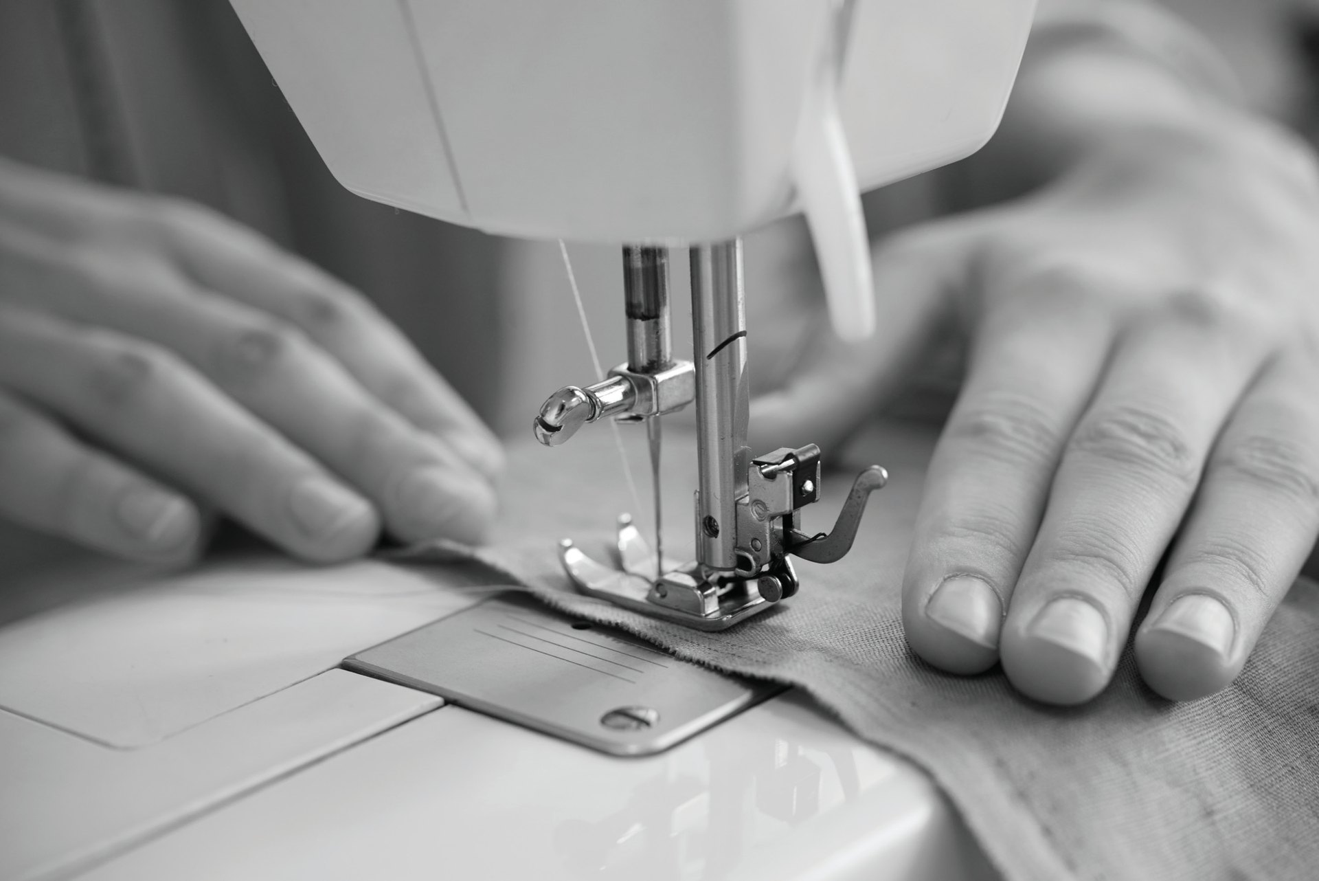 Close-up of a garment being stitched on a sewing machine